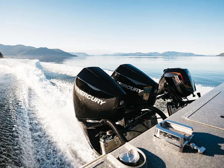 Ferry Marine - Mercury four stroke outboards diagnostics Two black Mercury Four Stroke outboards on the transom of a boat under way across open water