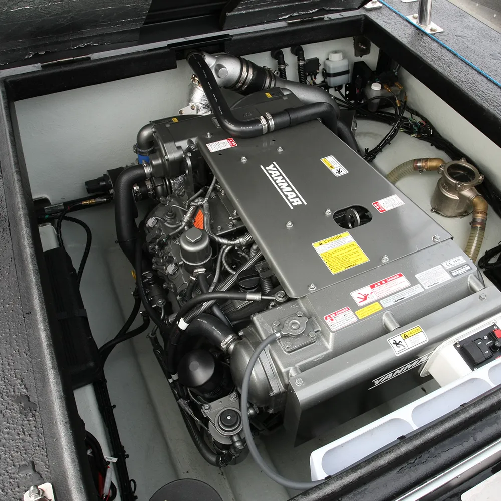 Yanmar inboard diesel installed in a XS RIB Yanmar inboard marine diesel engine installed in the engine box of a XS RIB, with hoses, wiring and raw-water strainer