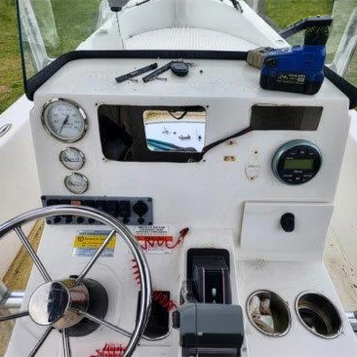 Before: a tired console ready for a new dashboard Boat console before a dashboard refit, with old gauges, a switch panel, a cut-out hole where the old display sat and patched screw holes